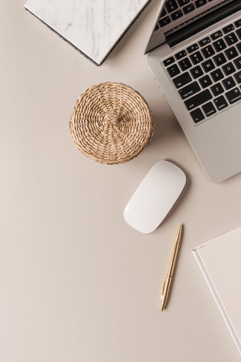 Laptop, Rattan Container, Mouse, and Pen on Beige Background Flatlay